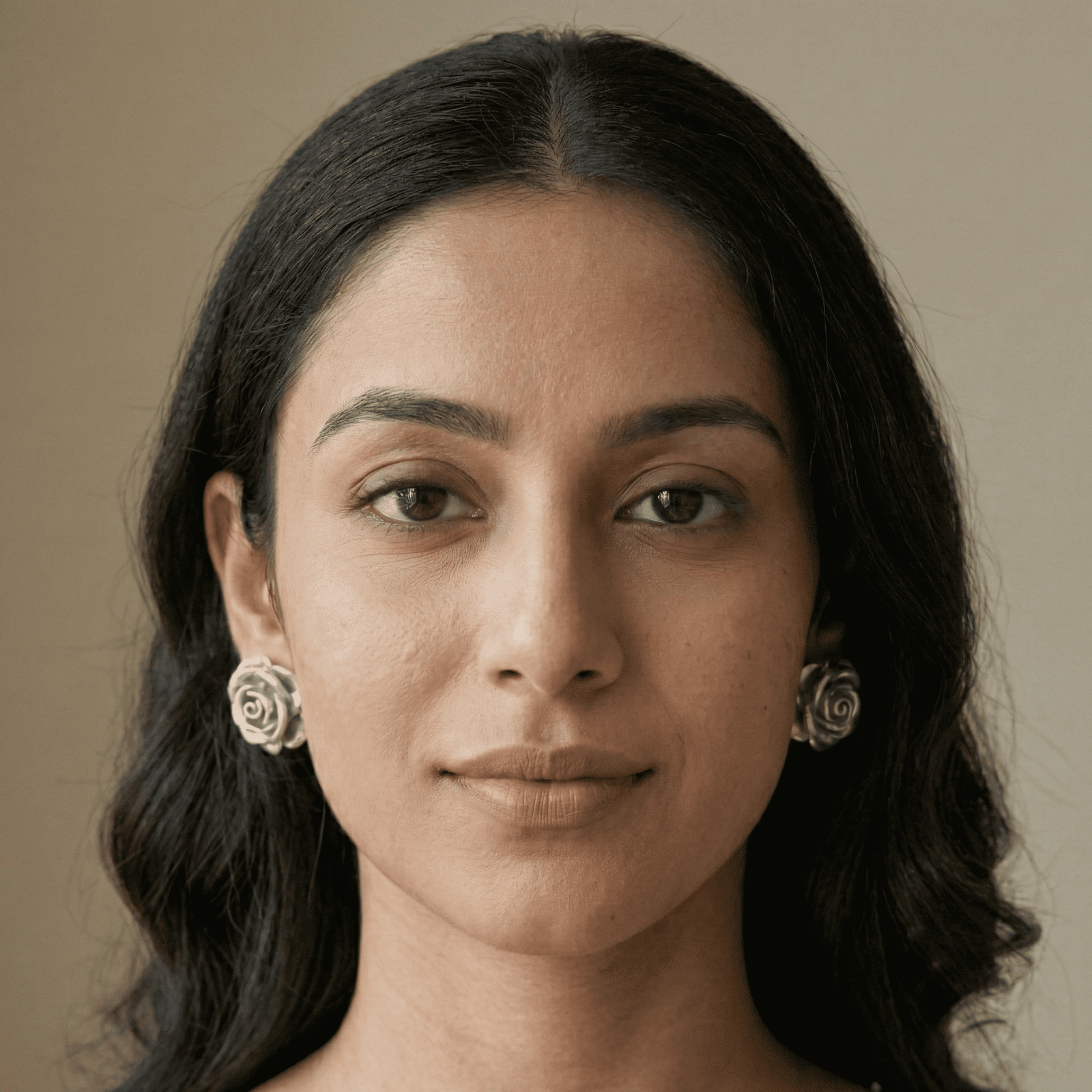 Model wearing silver rose stud earrings for women
