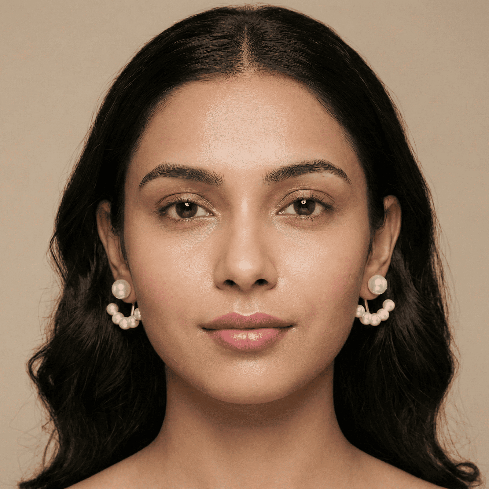 Woman wearing crystal stud earrings with detachable pearl jacket design