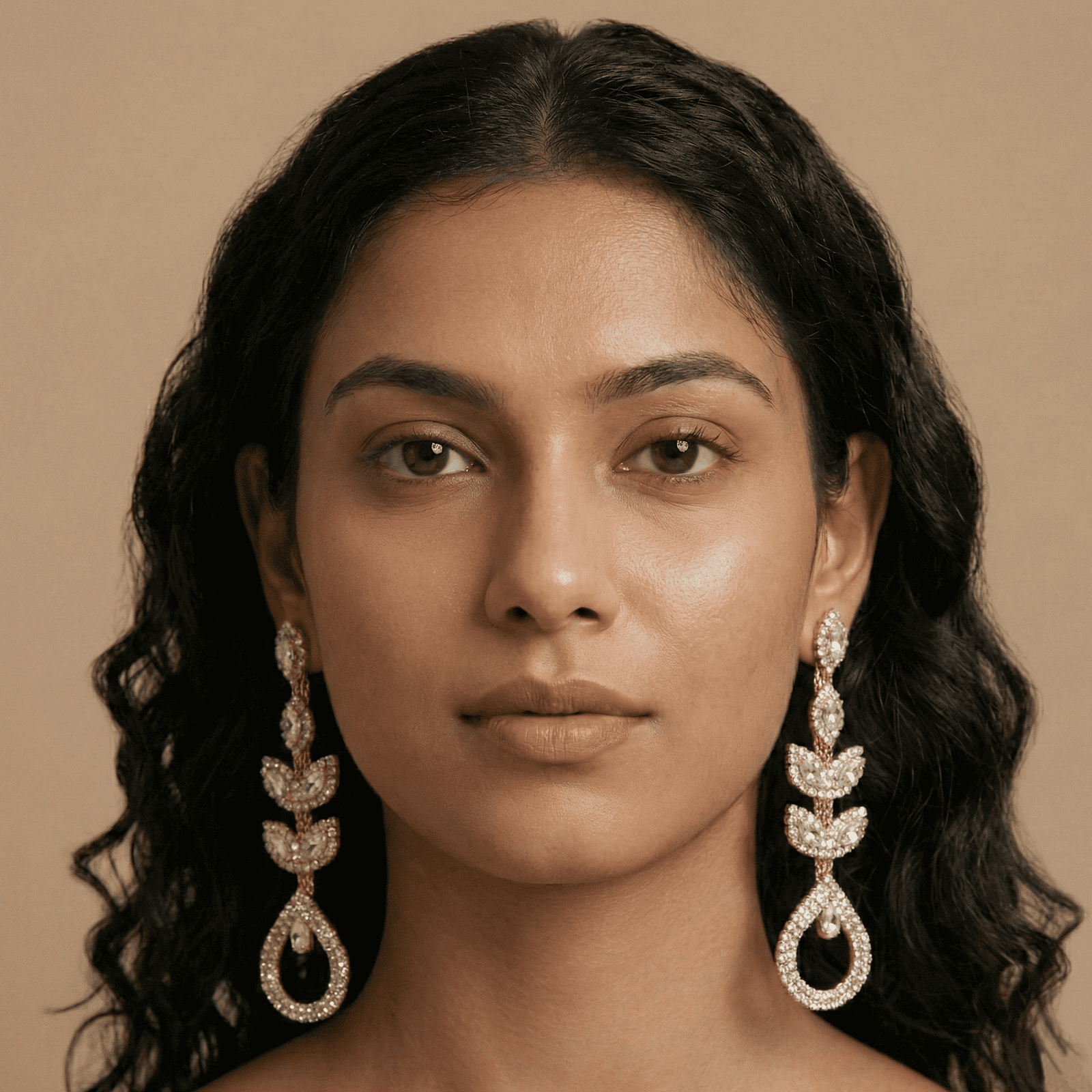 Woman wearing Eshanarya crystal vine drop earrings with leaf detailing