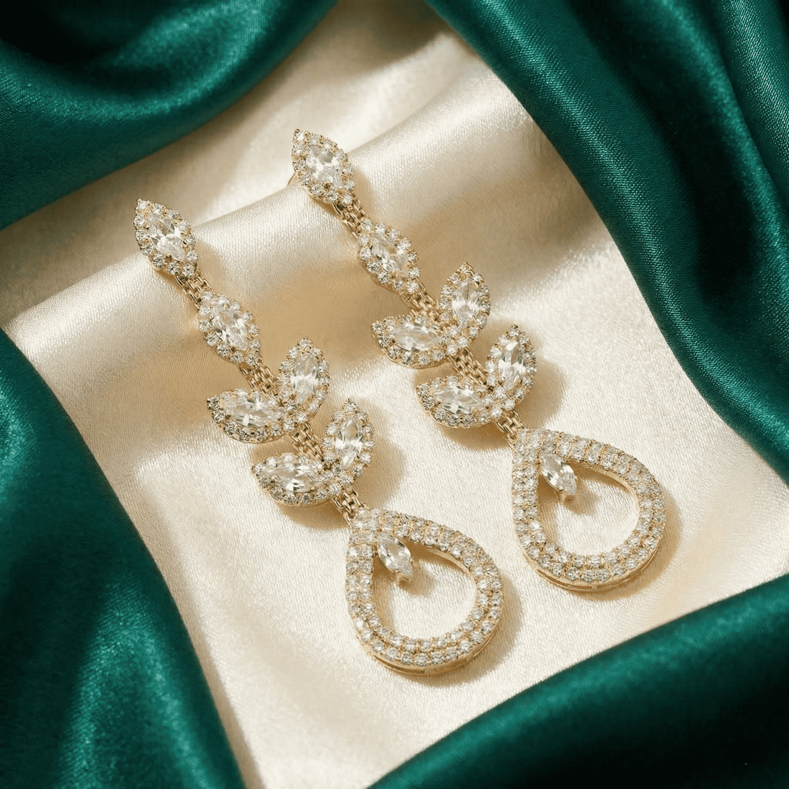 Luxury look crystal drop earrings on satin background