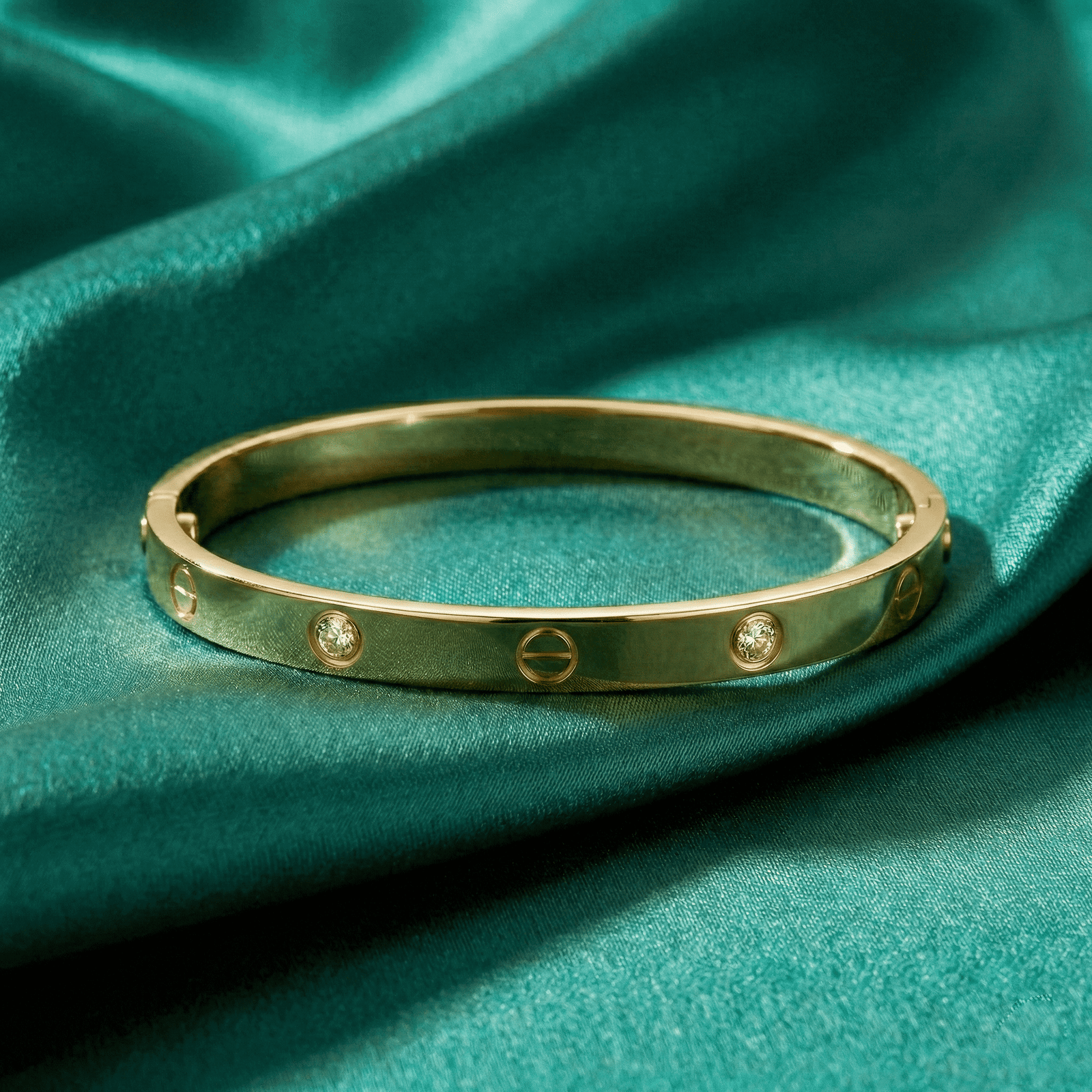 Gold-tone stainless steel bracelet for women on green satin fabric