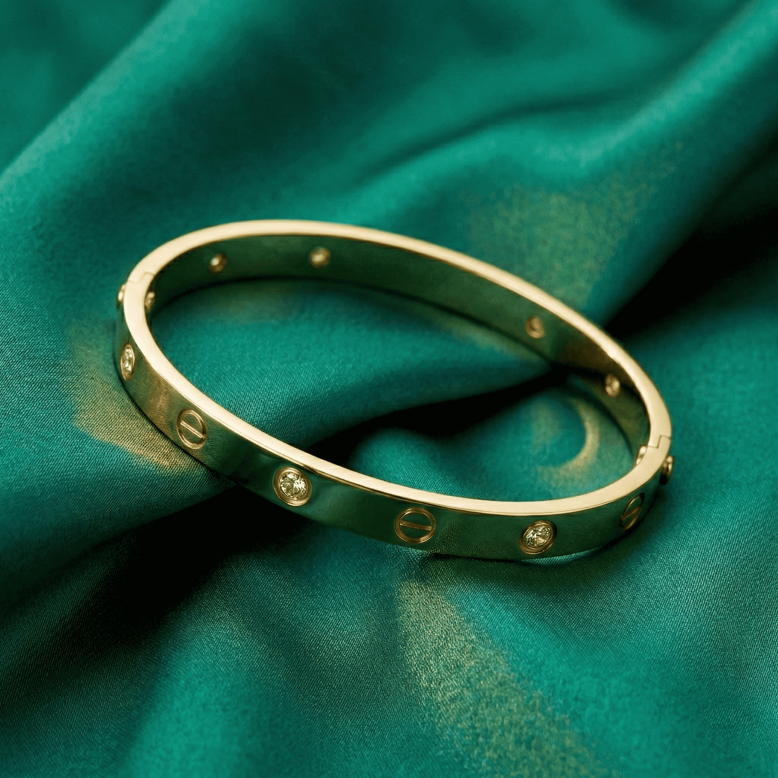 Slim gold-tone anti-tarnish bracelet for women on satin background