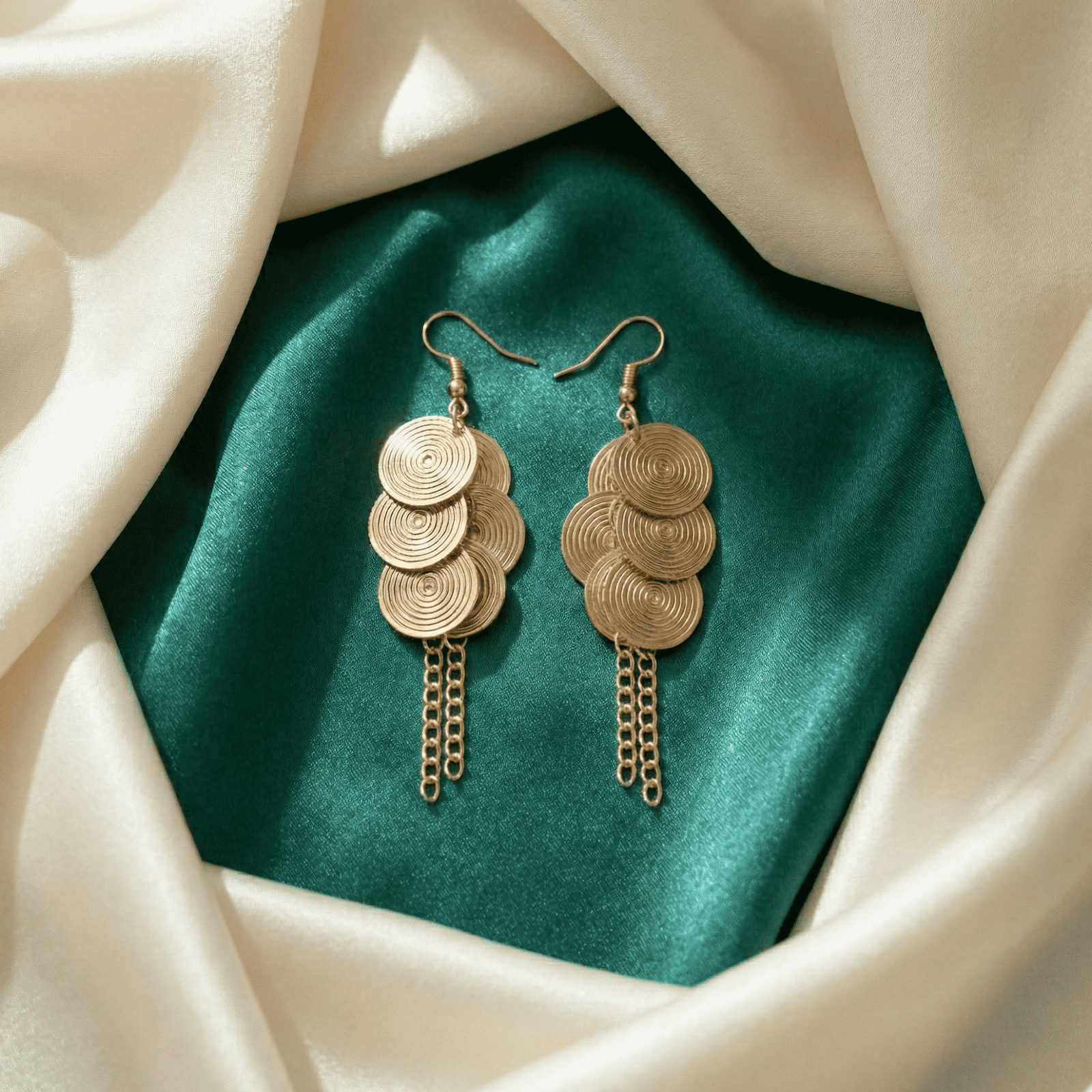 Lightweight gold tone dangle earrings for women with layered spiral discs and tassel drops