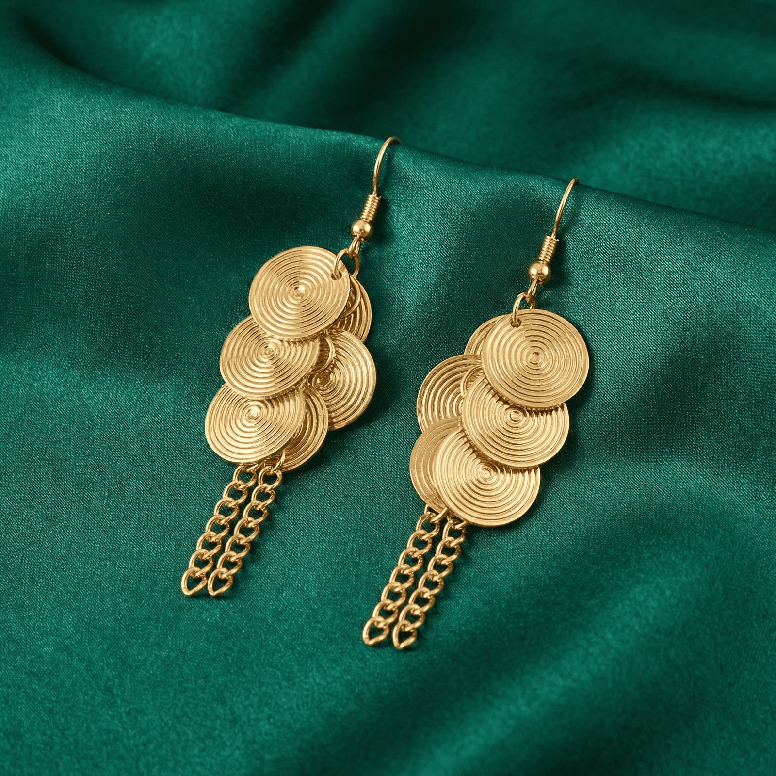 Statement gold tone disc drop earrings with chain tassels and spiral textured detailing
