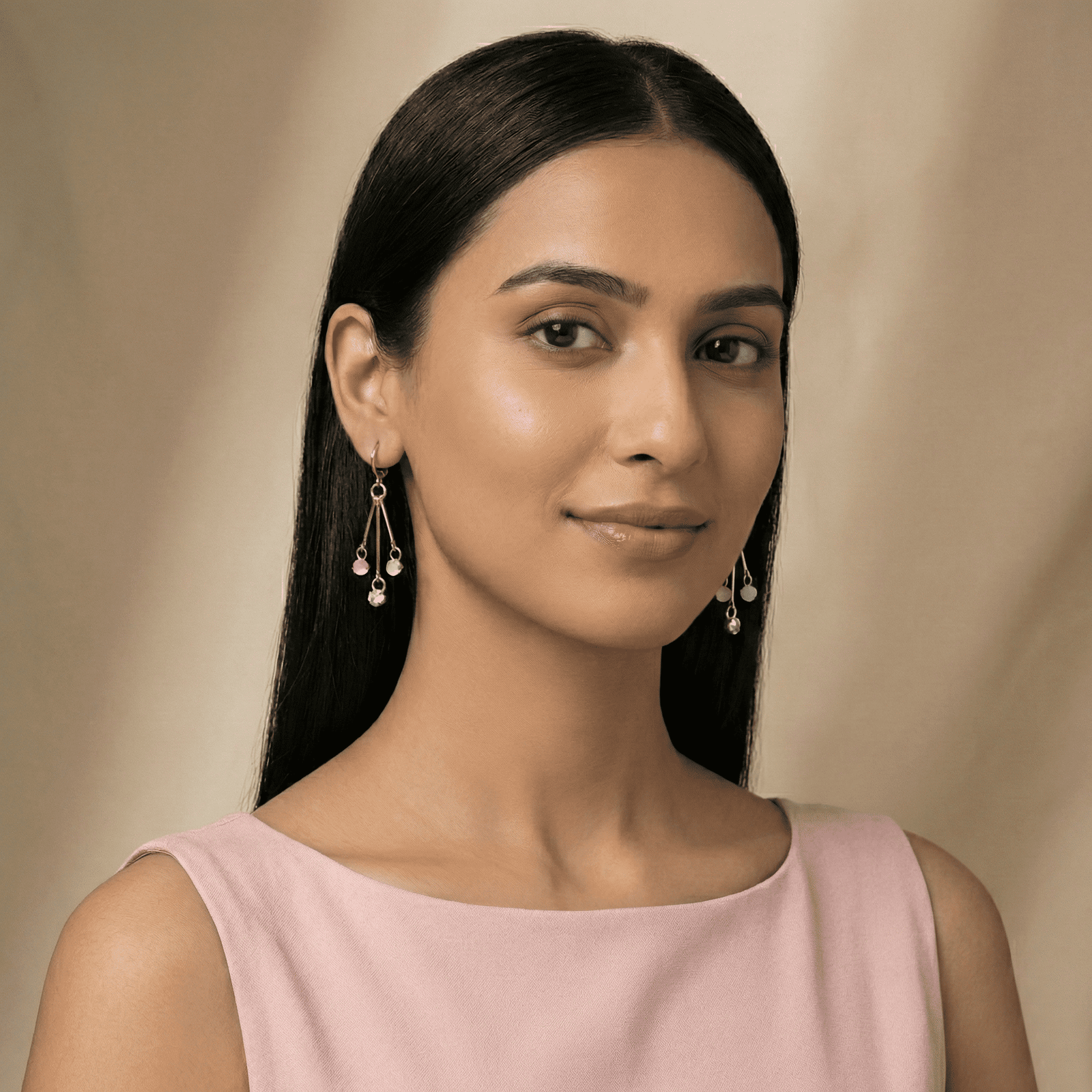 Woman wearing Eshanarya pastel drop hoop earrings with pink outfit