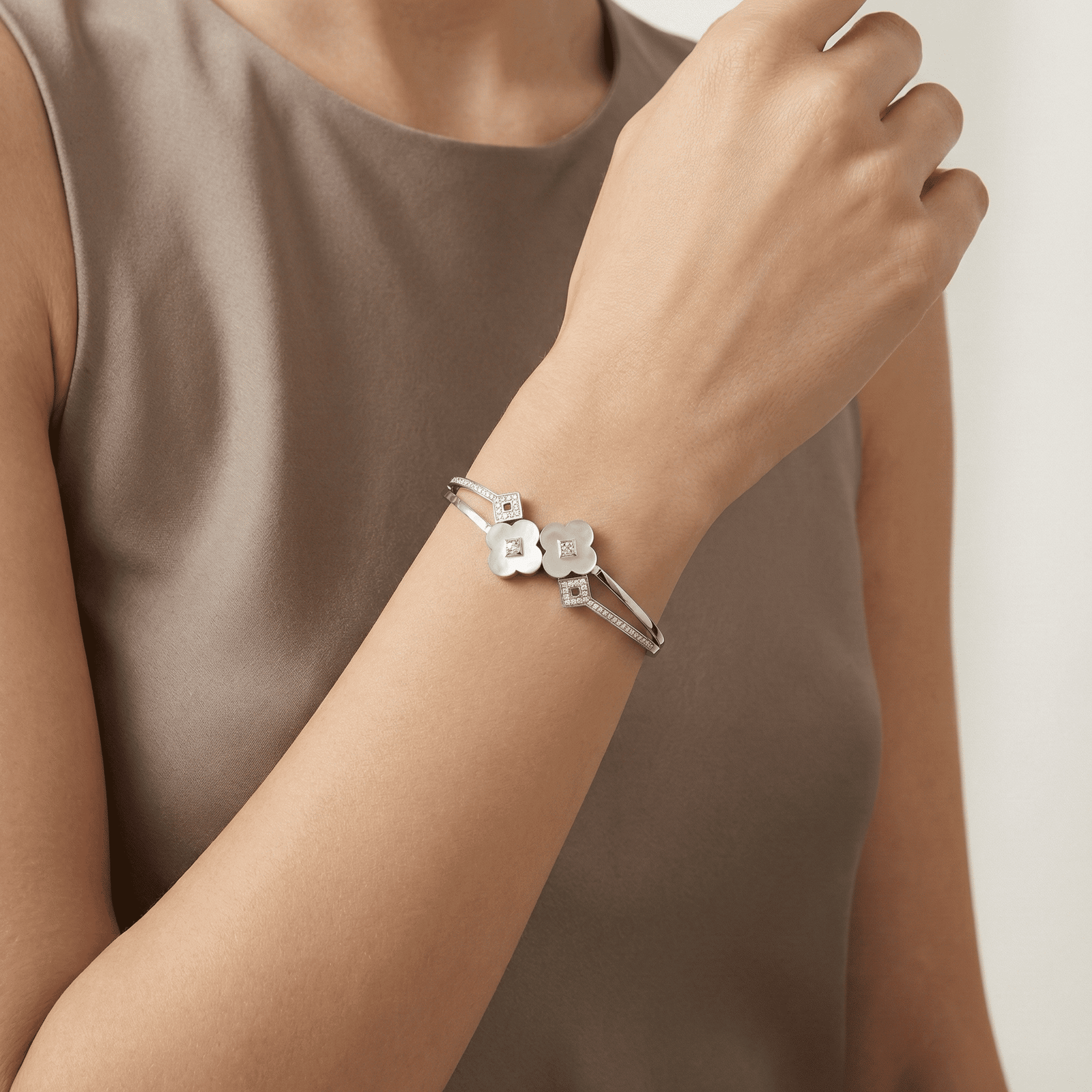 Silver tone stainless steel bracelet worn on wrist for modern women styling