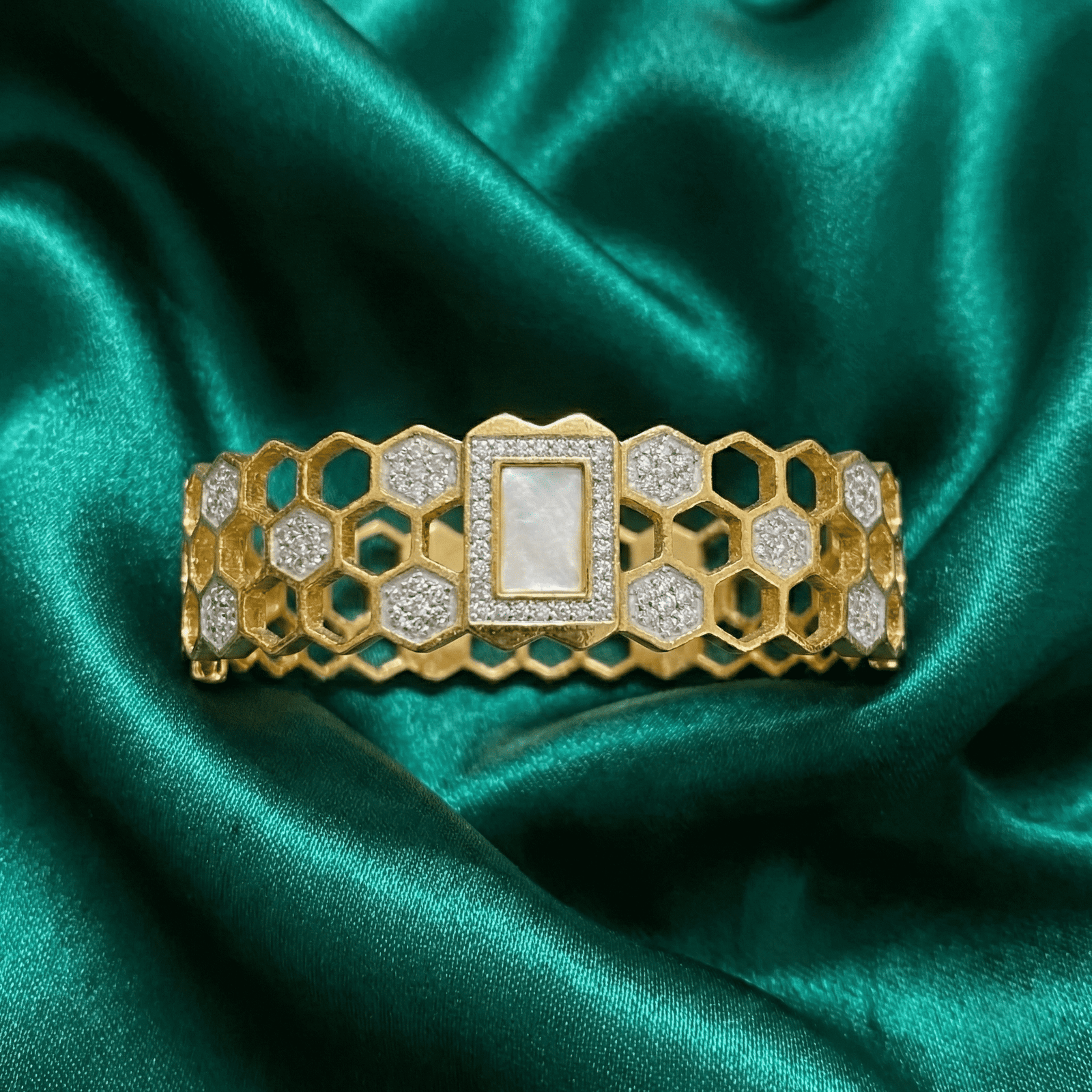 Gold-tone honeycomb crystal bracelet for women on green satin fabric