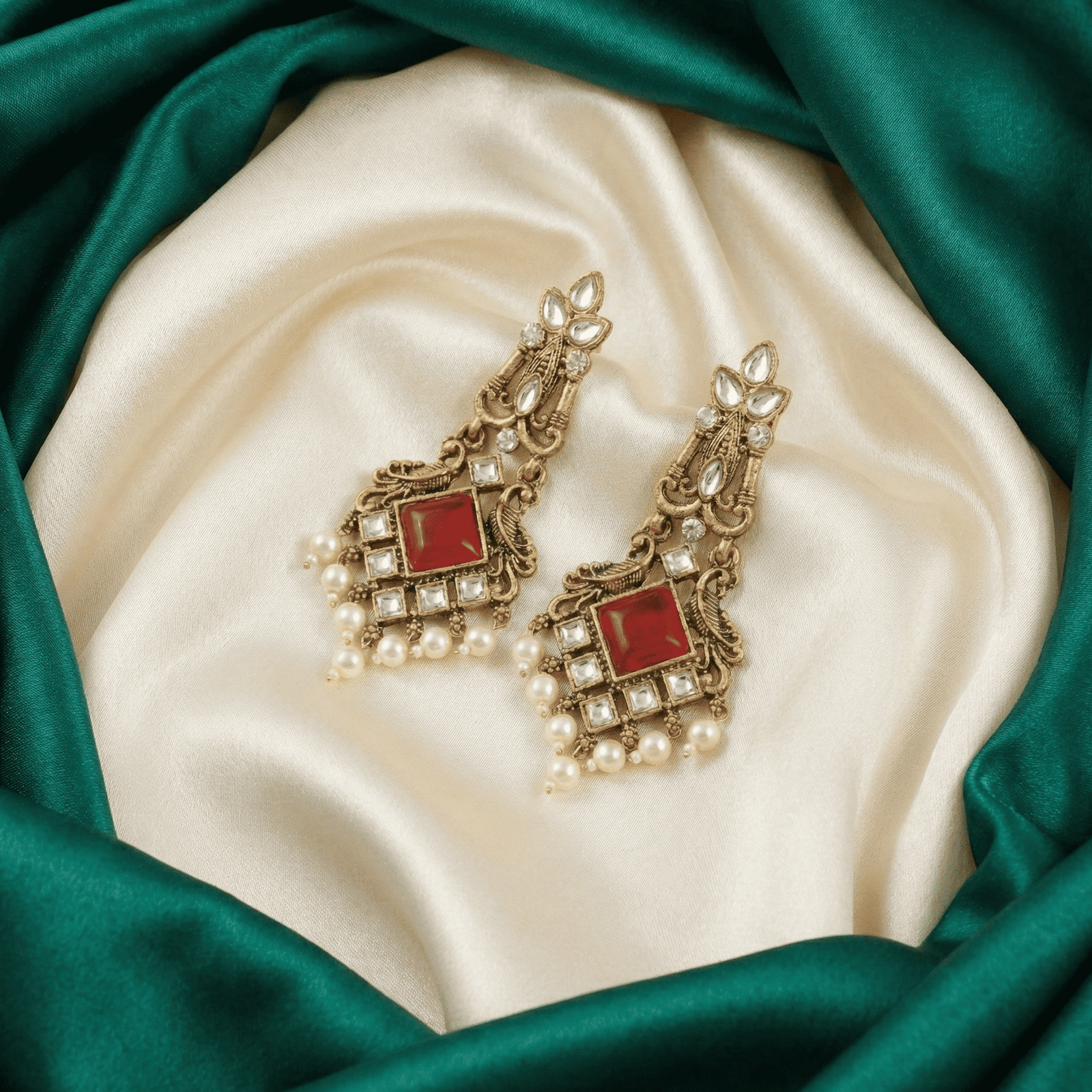 Traditional festive earrings with ruby red stone, kundan crystal work and pearl hangings for women