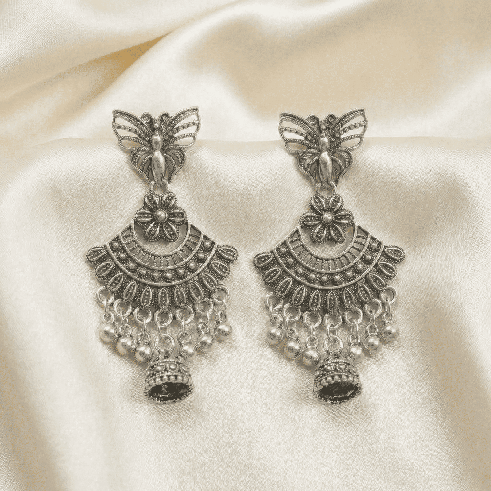 Statement oxidised silver butterfly earrings with engraved detailing and hanging silver bead accents