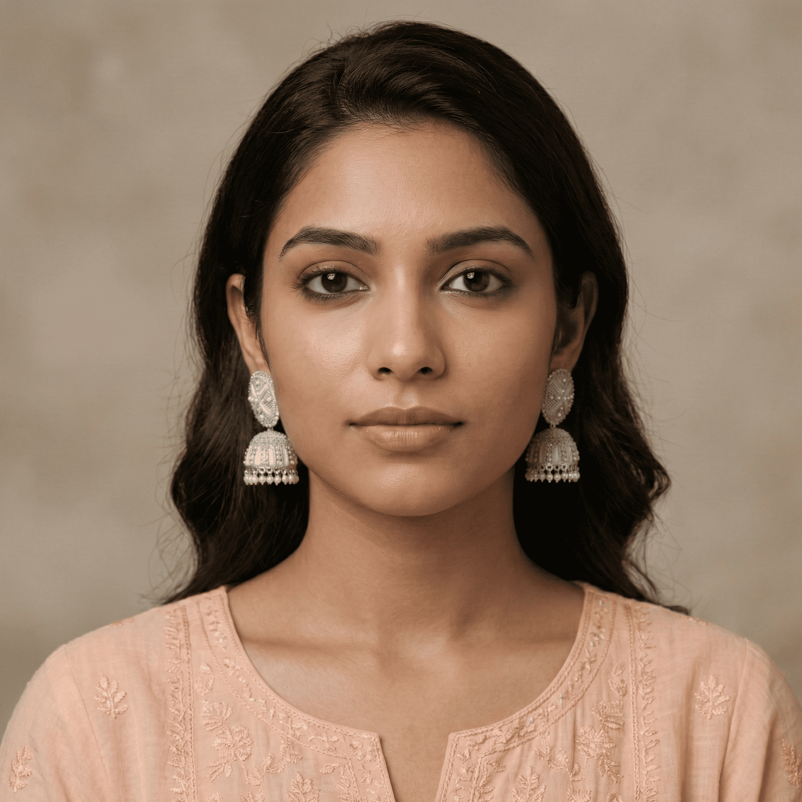 Woman wearing oxidised silver mirror-style jhumka earrings