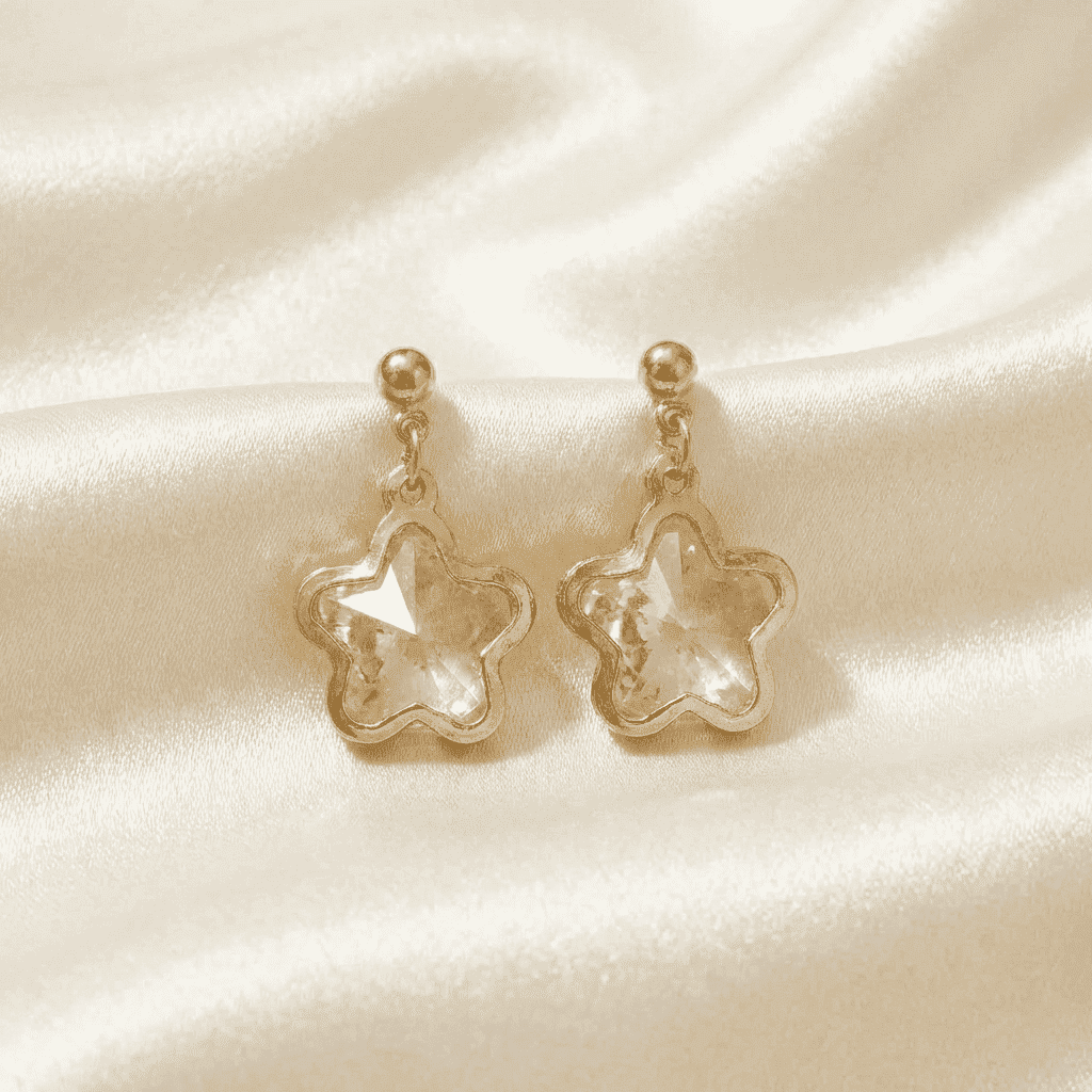 Gold tone star earrings for women with sparkling faceted crystal centerpiece