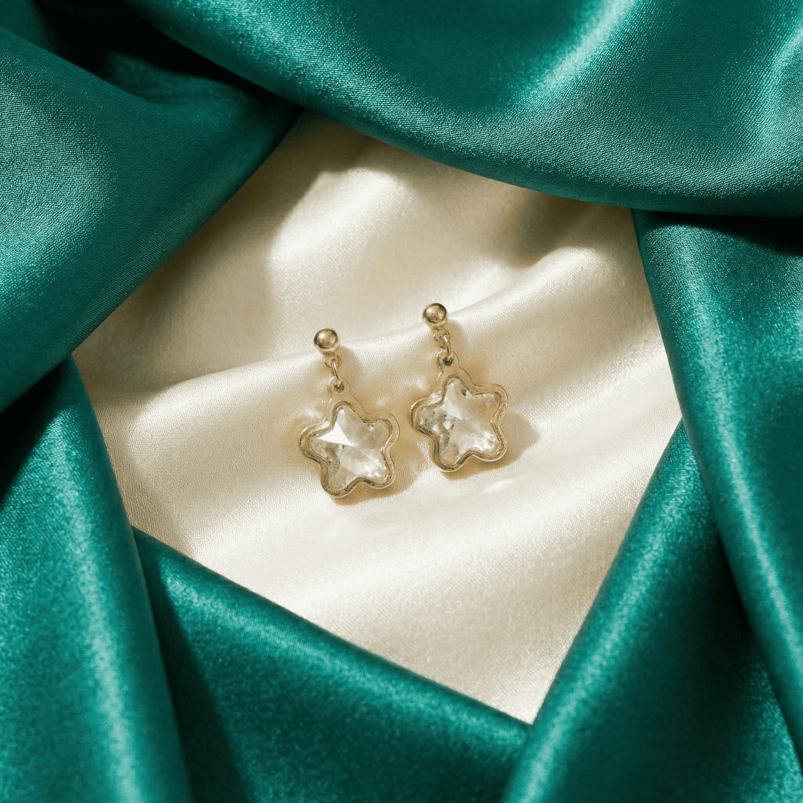 Women's crystal star dangle earrings with gold tone frame and push back closure