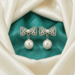Silver bow pearl drop earrings with crystal accents