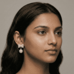 Model wearing pearl bow drop earrings for women