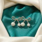 Silver pearl bow stud earrings close-up view