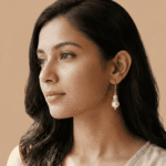 Woman wearing crystal halo pearl drop earrings