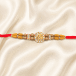 Eshanarya Lord Ganesha Crystal Designer Rakhi with wooden beads and red cotton thread on blue satin background