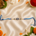 Blue Nazar Designer Rakhi displayed with diya, kumkum and festive décor for Raksha Bandhan celebrations.