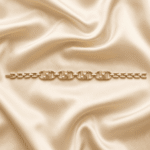 Eshanarya Gold Finish Geometric Crystal Bracelet Rakhi for Brother displayed on an off-white satin background.
