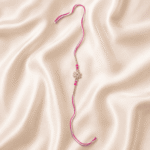 Eshanarya Pink Crystal Flower Designer Rakhi with pink thread on off-white satin background