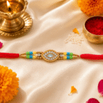 Gold finish crystal Rakhi for brother photographed with marigold flowers and traditional festive props