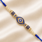 Close up angle of Blue Nazar Designer Rakhi with adjustable braided thread, crystal embellishments and pearl accents for brothers.