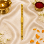 Vertical festive display of Eshanarya engraved Bracelet Rakhi with traditional Raksha Bandhan decorations on satin fabric