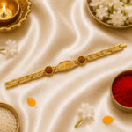 Festive lifestyle image of Eshanarya Mere Bhai Bracelet Rakhi with diya, kumkum, rice and jasmine flowers on satin background