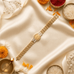 Lifestyle image of the Eshanarya Gold Finish Radhe Radhe Bracelet Rakhi arranged with traditional Raksha Bandhan decorations including diya, kumkum, rice and marigold petals.