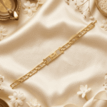 Lifestyle image of Gold Finish Jai Mata Di Bracelet Rakhi displayed with traditional Raksha Bandhan decorations on satin fabric.
