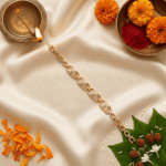 Lifestyle image of Eshanarya geometric gold Bracelet Rakhi with traditional Raksha Bandhan decorations on an off-white satin backdrop.