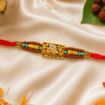 Mahakal Rudraksha Rakhi displayed with diya, kumkum, marigold petals and betel leaves for Raksha Bandhan
