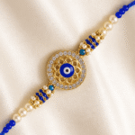 Traditional Blue Evil Eye Rakhi for brother featuring crystal stones, pearl accents and premium thread