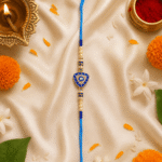 Blue Evil Eye Triangle Rakhi for Brother with crystal detailing showcased in a festive Raksha Bandhan arrangement with diya and flowers.