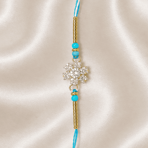 Vertical close-up of Sky Blue Crystal Designer Rakhi with blue beads and golden accents