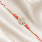 Detailed crystal snowflake Rakhi with festive red bead accents
