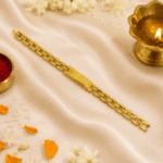 Festive flat lay of Eshanarya engraved Bracelet Rakhi with traditional pooja elements including diya, kumkum, rice and flower petals
