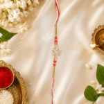 Premium Raksha Bandhan photography of Red Crystal Snowflake Designer Rakhi with traditional festive décor