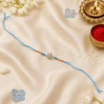 Luxury festive flat lay of Eshanarya Sky Blue Crystal Designer Rakhi with Raksha Bandhan decorations