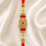 Close-up of Eshanarya Royal Floral Crystal Rakhi with pearl beads and ruby-red accents