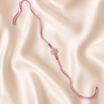 Angled view of Pink Crystal Flower Designer Rakhi with premium pink thread for Raksha Bandhan