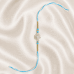 Vertical view of Sky Blue Crystal Snowflake Designer Rakhi with blue beads and white thread
