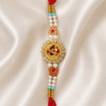 Front view of designer Om rakhi with crystal border and pearl bead detailing for Raksha Bandhan