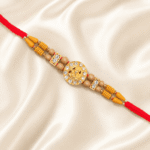 Close-up of Eshanarya Ganesha Crystal Rakhi with gold-tone Ganesha charm and decorative wooden beads