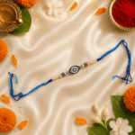 Premium Blue Nazar Designer Rakhi for Brother with crystal evil eye design, pearl accents and traditional festive styling.