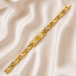 Angled view of Eshanarya gold finish Om Bracelet Rakhi with sparkling crystal detailing and modern bracelet design