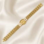 Angled view of Eshanarya Gold Finish Radhe Radhe Bracelet Rakhi with polished chain links on a soft satin fabric.