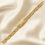 Angled flat lay of Jai Mata Di Gold Bracelet Rakhi with sparkling crystal details and minimalist bracelet chain.
