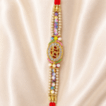 Close-up of BRO crystal centre motif with pearl beads and multicolour decorative beads designer rakhi