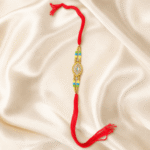 Vertical product photo of gold finish designer Rakhi with multicolour beads and traditional red thread